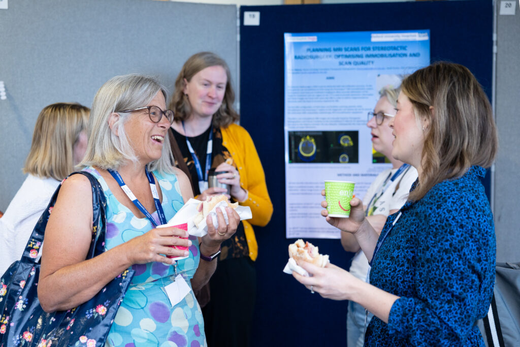 People at a conference by a poster