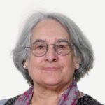 Photo of Megan Turmezei, with glasses and a colourful scarf